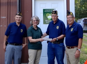 Commander of the post, Dave Commeau, Bob Shamroth, Bill Quinn present Mandy Hogan with $1,000 from their Southern BBQ benefit.